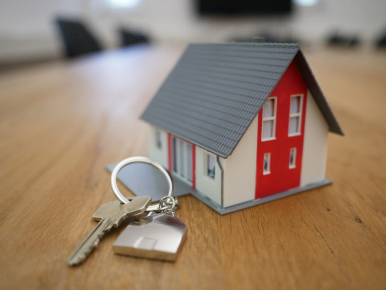 A picture of a small home with keys in front of it