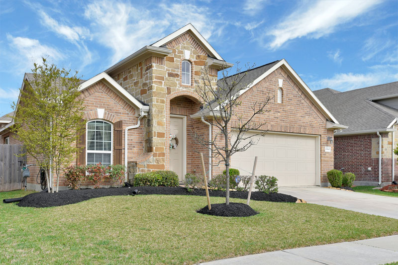 An exterior picture of a brick and stone build house