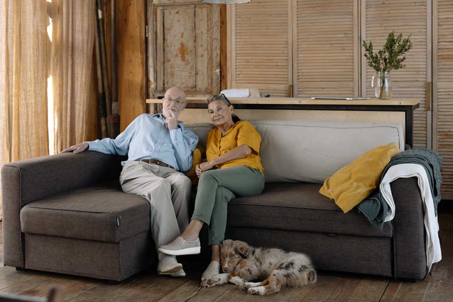 a senior couple sitting together on a couch